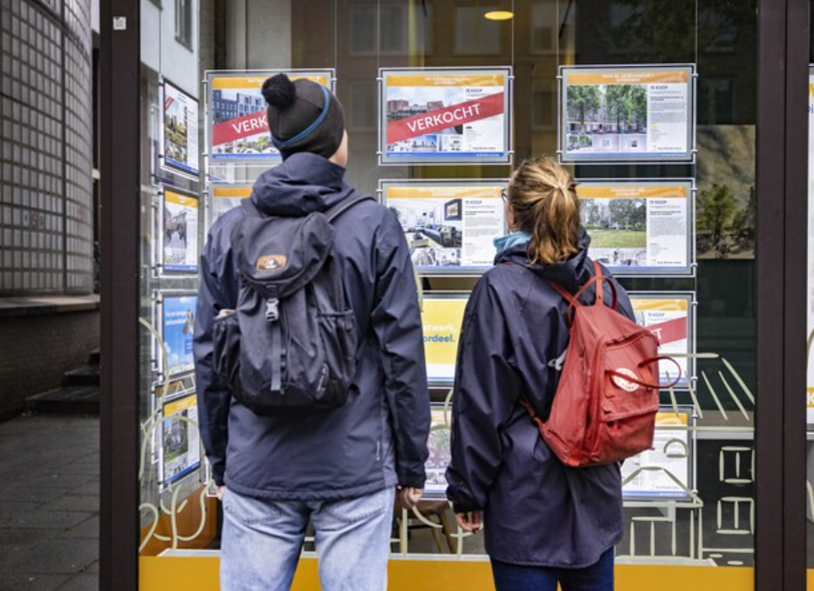 Mensen staan bij een makelaar kantoor
